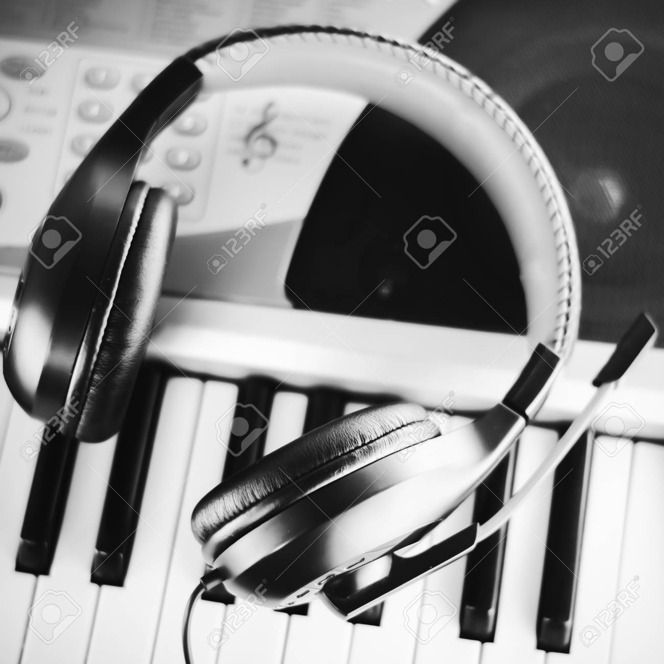 headphones on electric piano keyboard black and white color tone